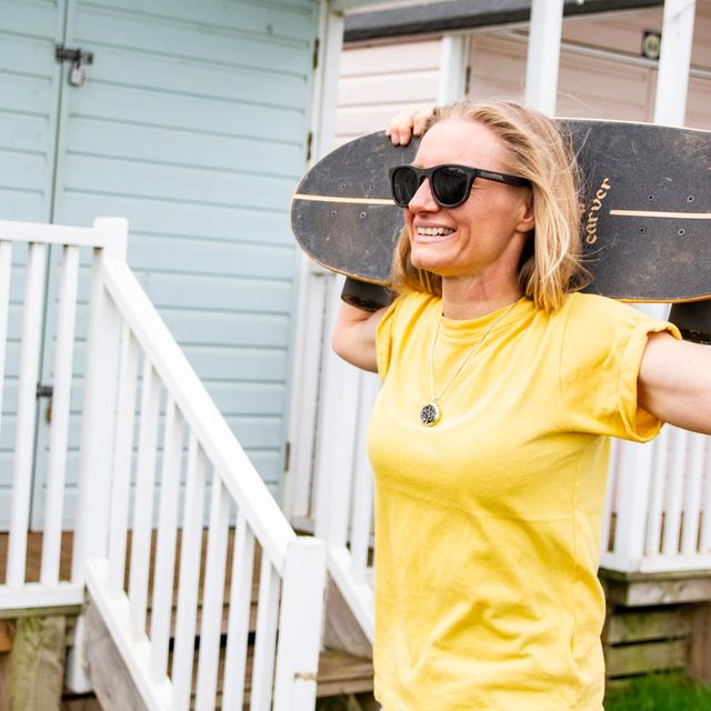 Stella Grace holding a skate board
